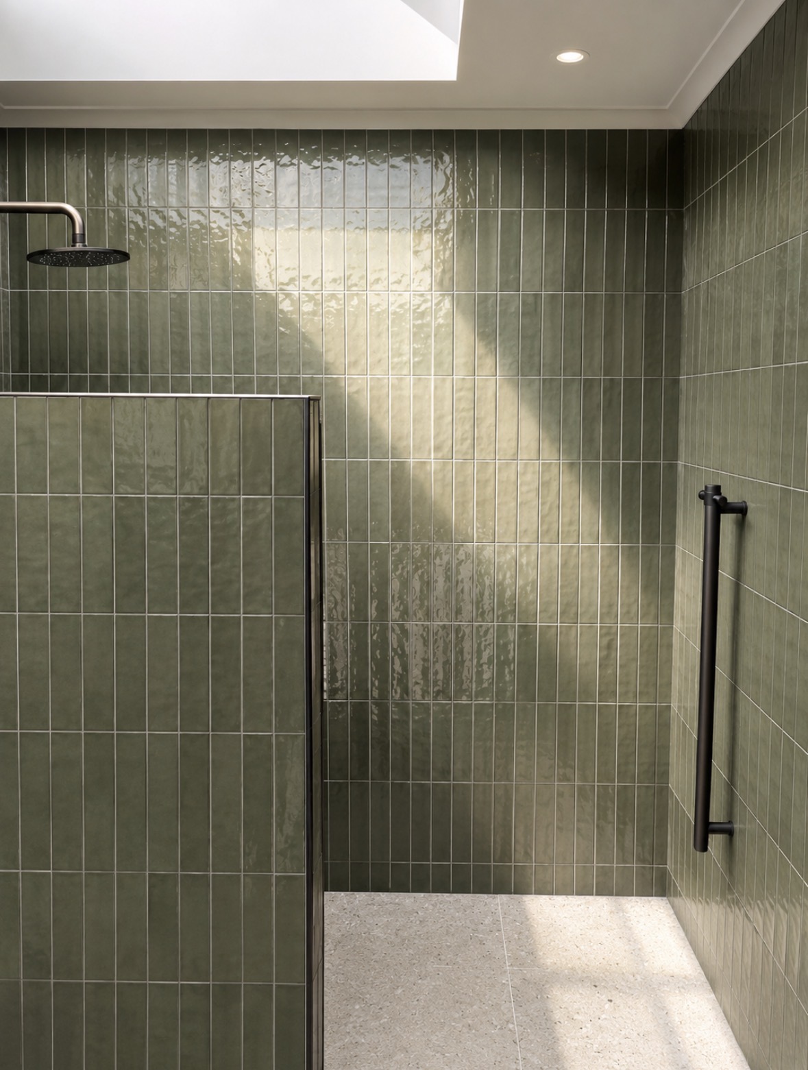 Sage green tiled walk-in shower with black fittings